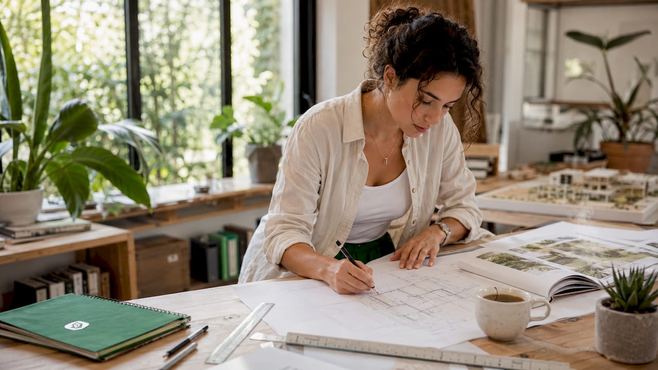 Architect sketching home design plans in studio