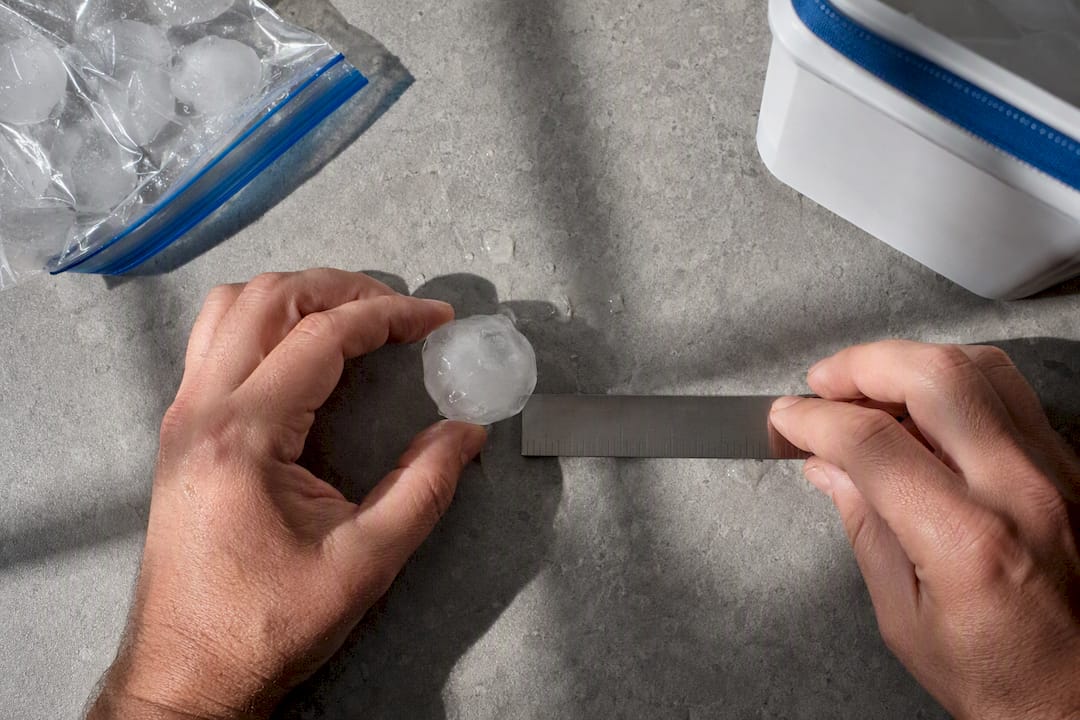 Frozen hailstone measured beside ruler