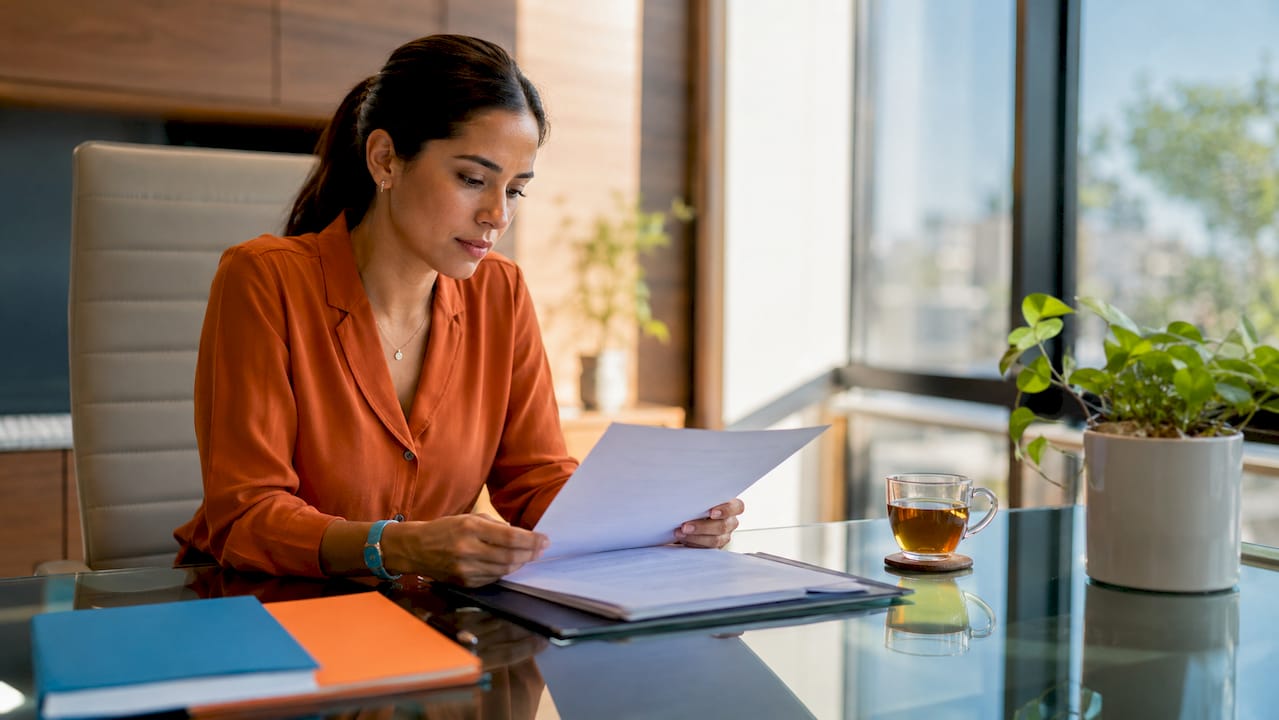 Hands reviewing insurance coverage documents