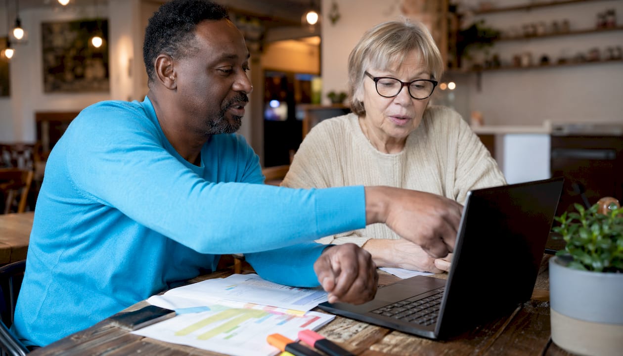 Couple reviewing home and auto insurance bundles at kitchen table