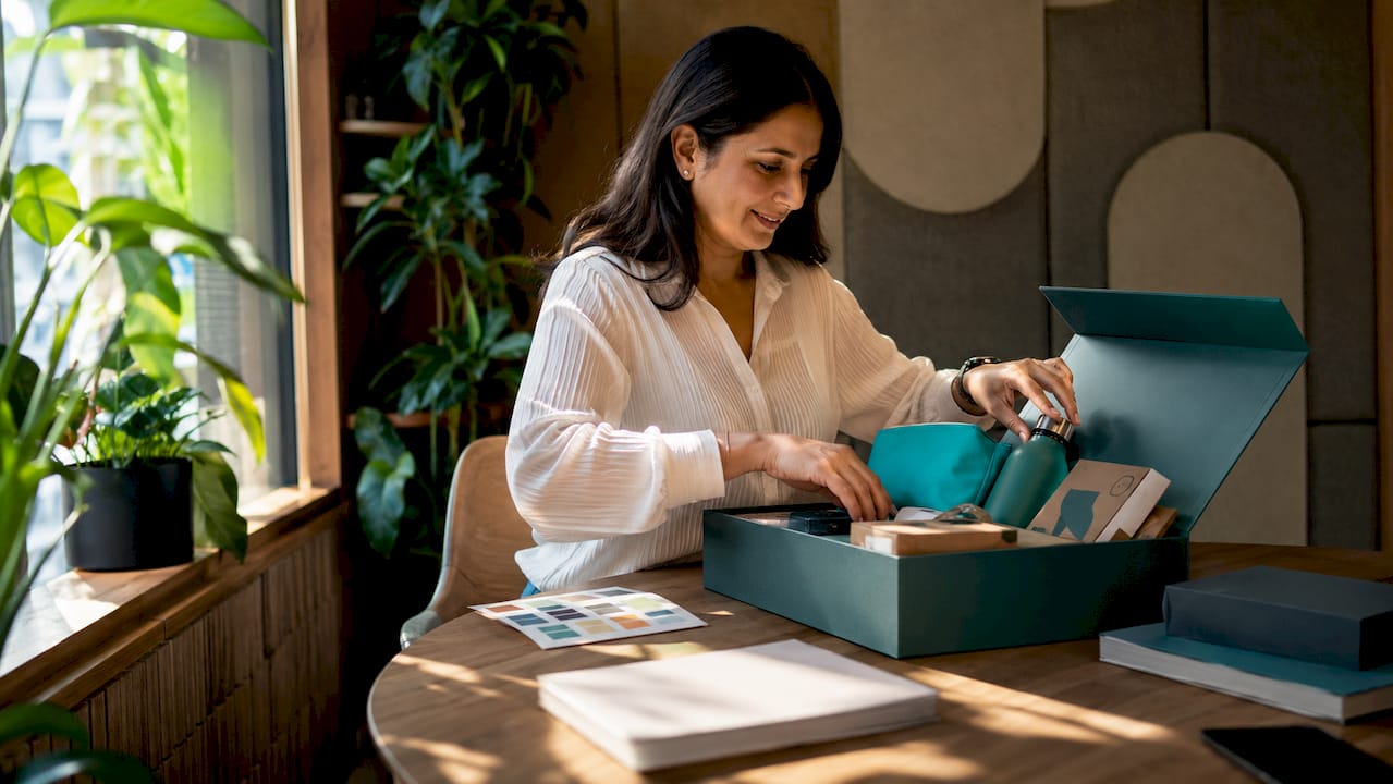 HR manager assembling branded corporate gift box