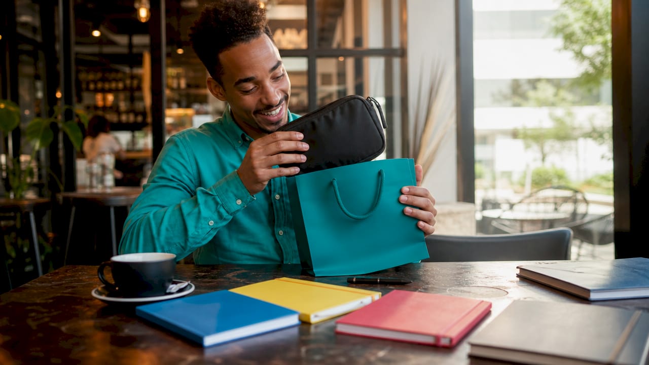 Employee happily opening corporate gift box