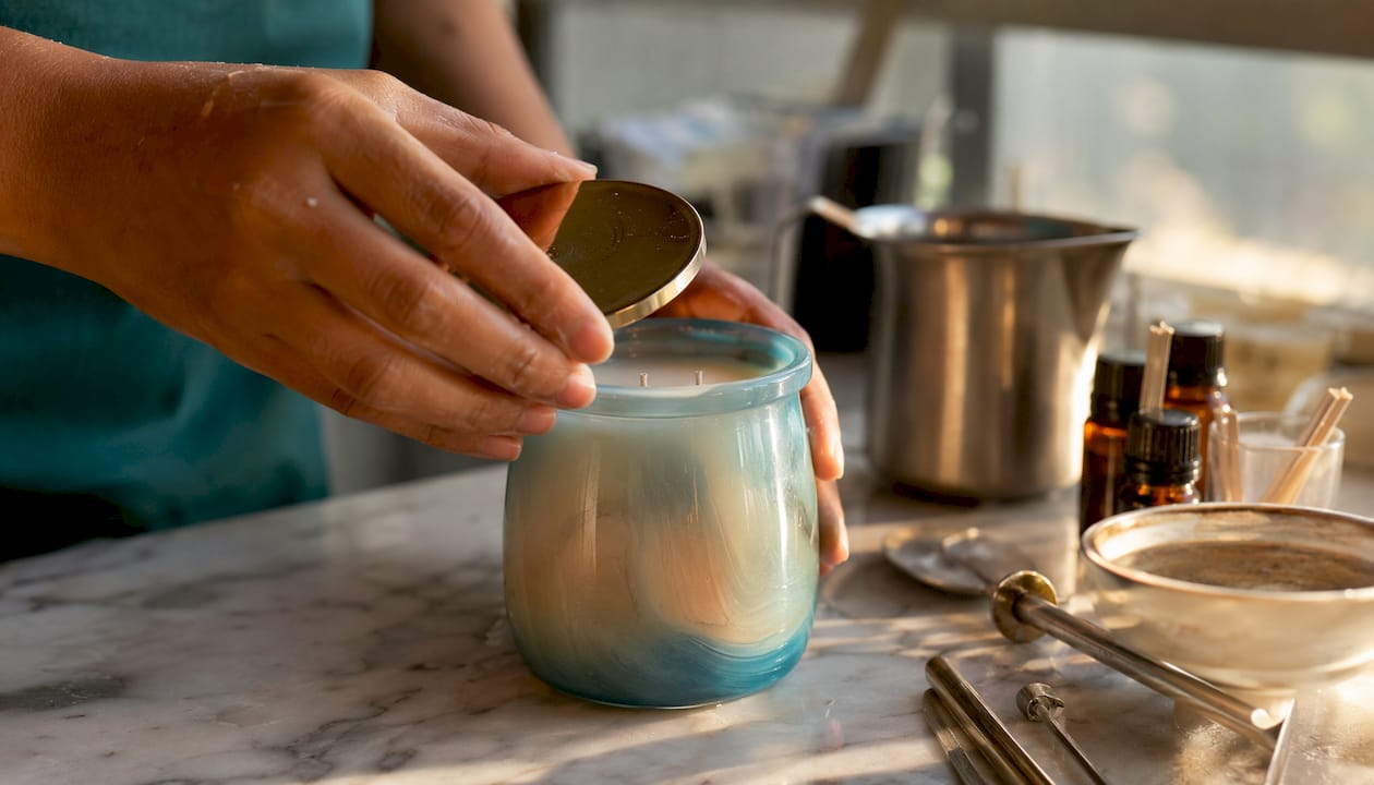 Hands inspecting luxury candle craftsmanship