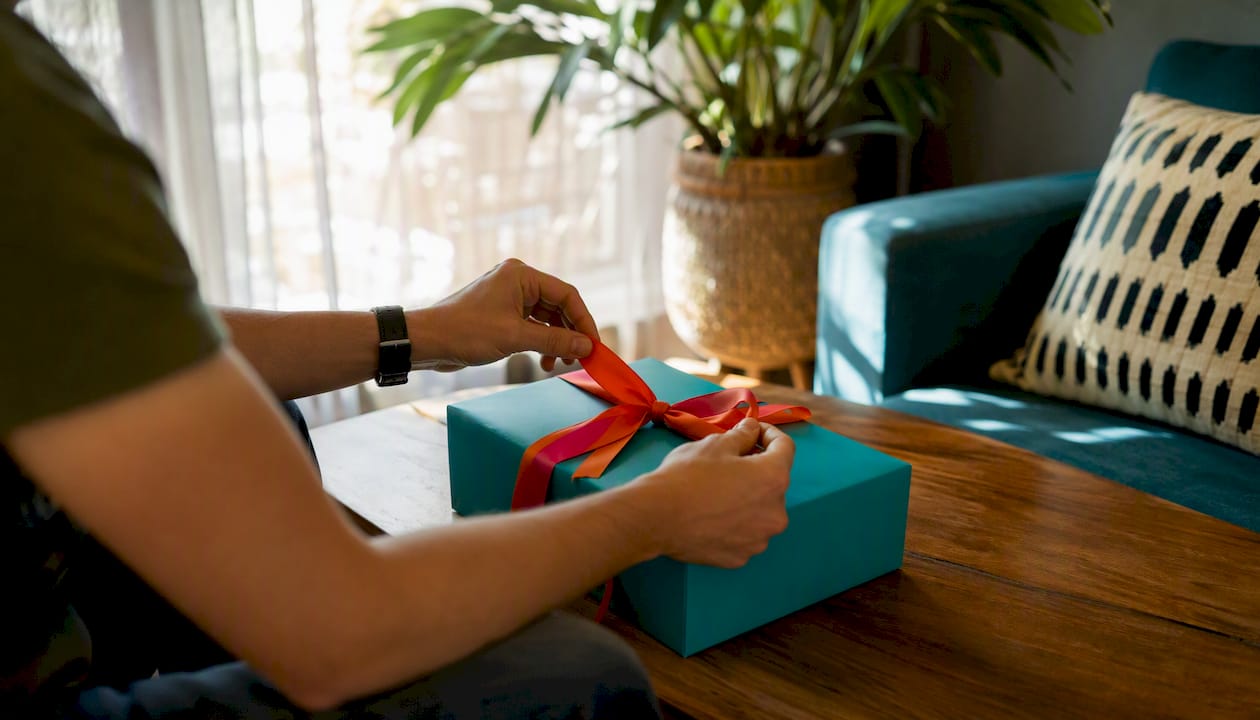 Hands sealing a corporate gift box near calendar