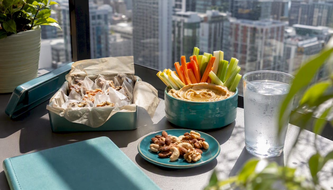 Healthy office desk snacks with dips and nuts