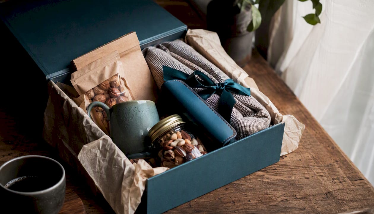 Open corporate gift box with assorted contents