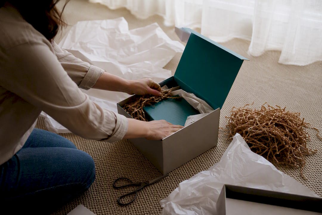 Hands assembling UK corporate gift box