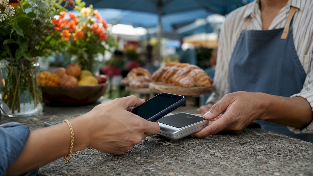 Customer using NFC tap-to-pay at coffee shop