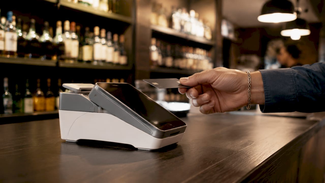 Close-up payment terminal with card at liquor store