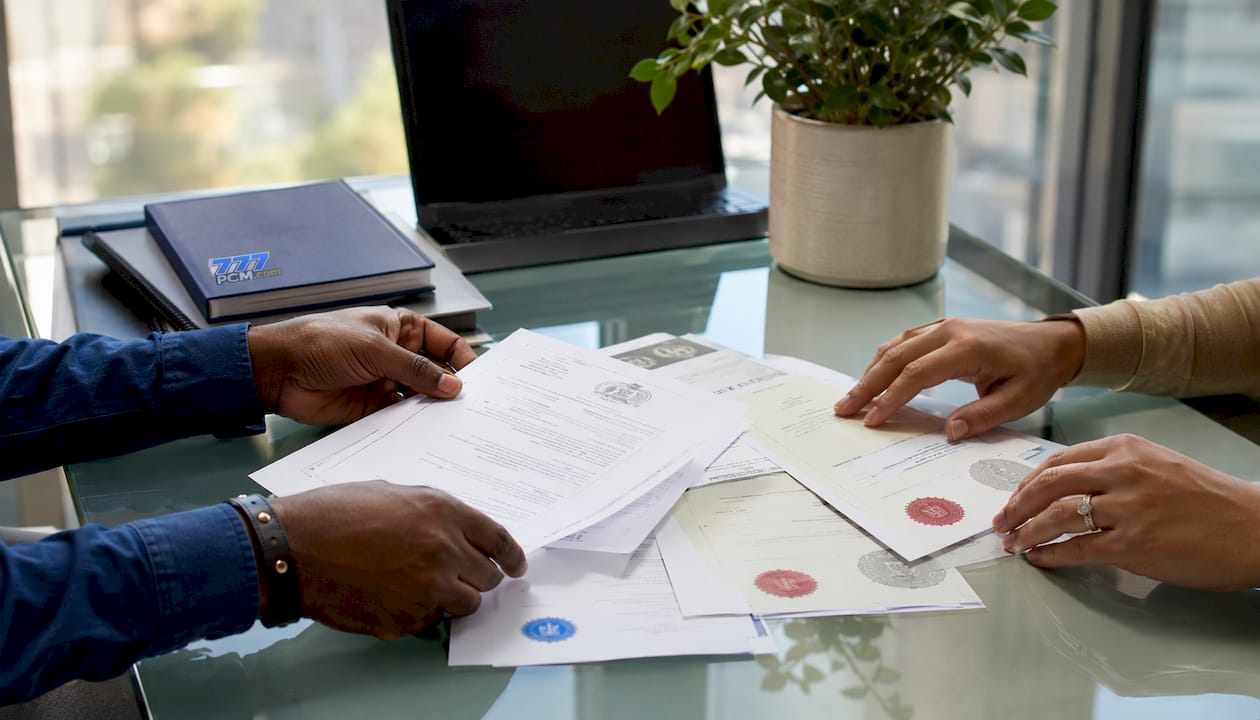 Hands sorting property compliance certificates