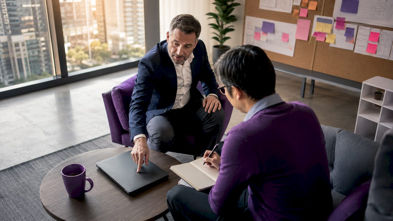 IT team discussing change management protocols in meeting