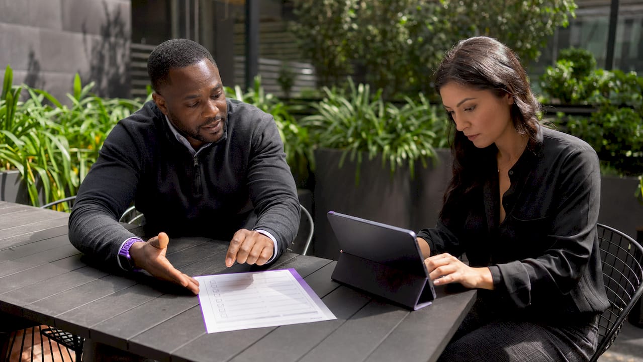 Two professionals mapping ISMS regulatory obligations