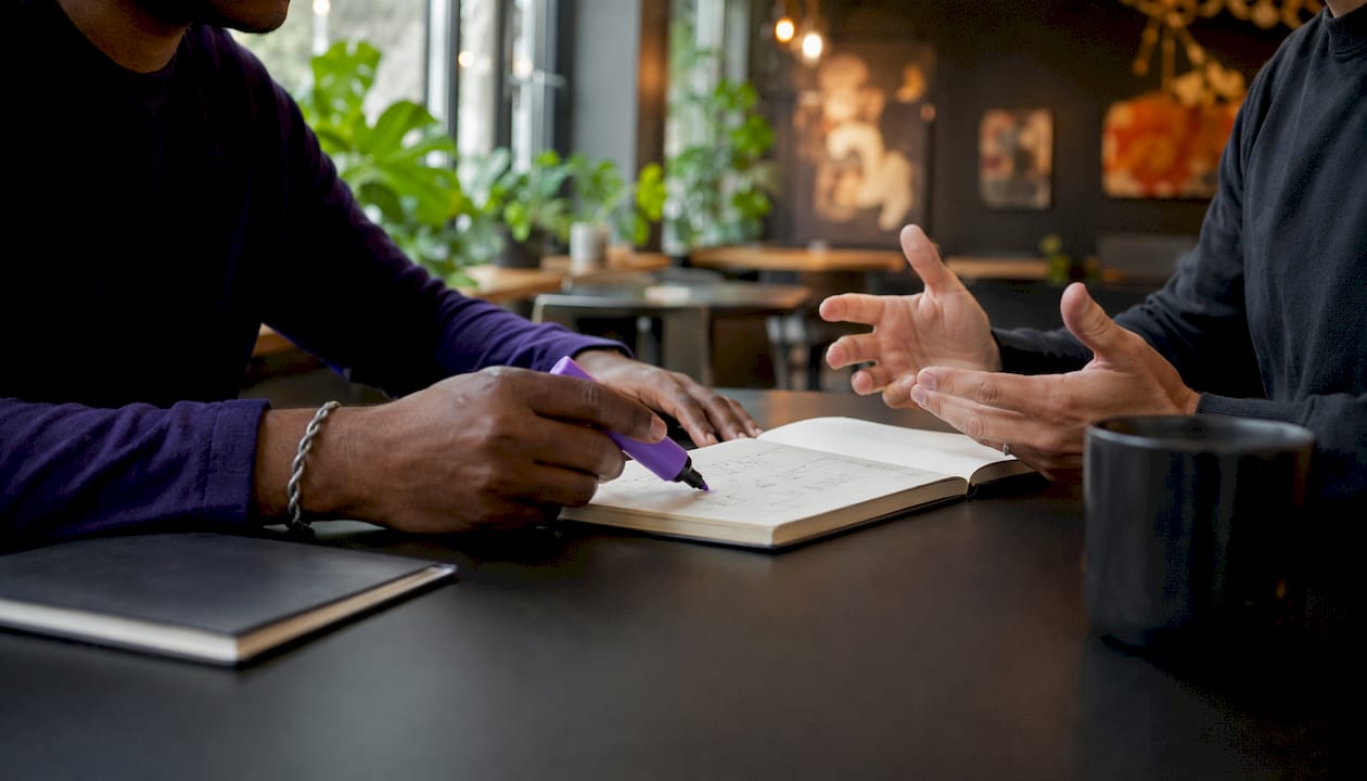 Hands collaborating on security-business alignment