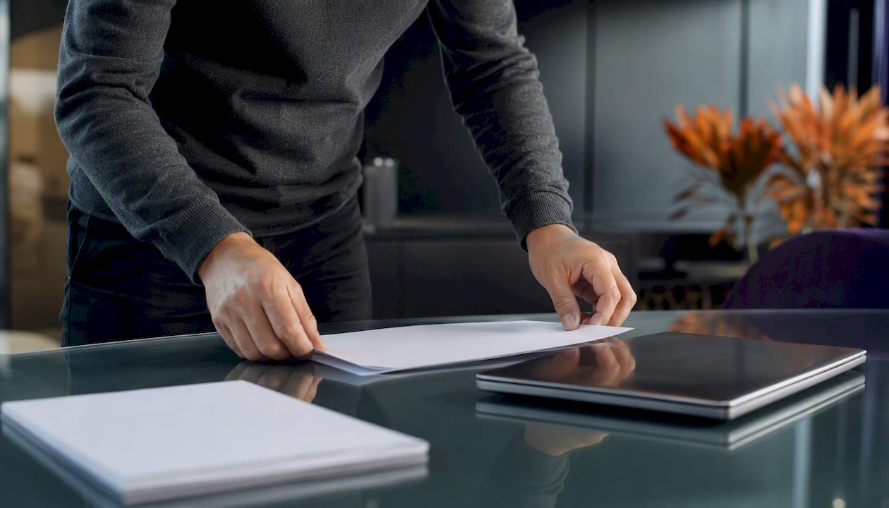 Hands arranging interview notes on desk
