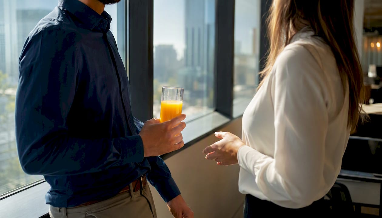 Hands pouring coffee during professional conversation
