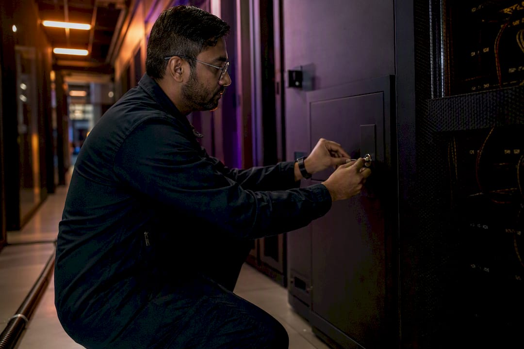 Hands adjusting security control lock in data center