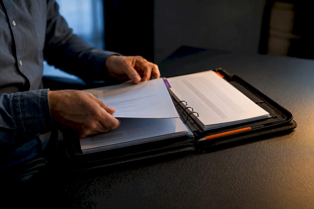 Hands organizing ISO audit report files