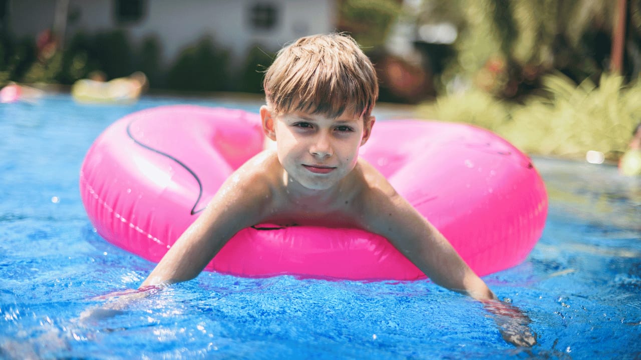 Father and toddler enjoying shallow pool water