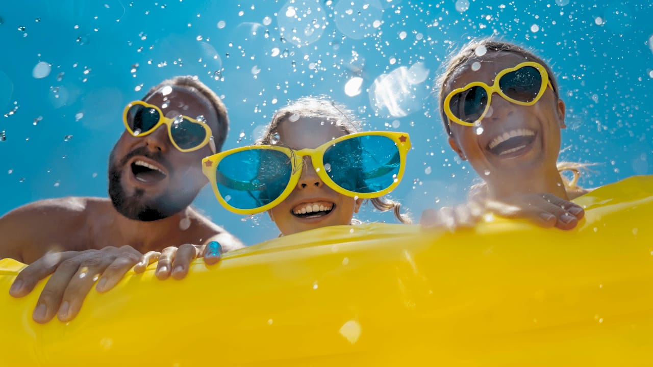Family enjoying medium backyard pool together