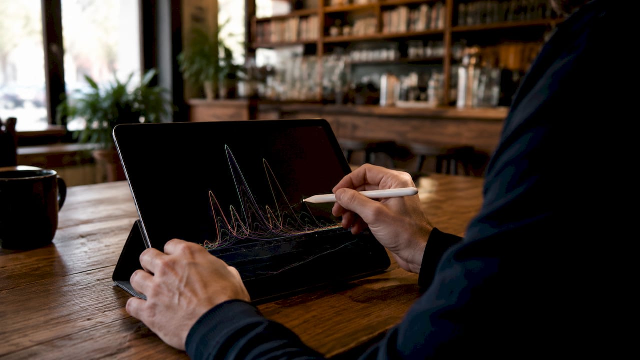 Hands adjusting asymmetric peak fitting curves on tablet