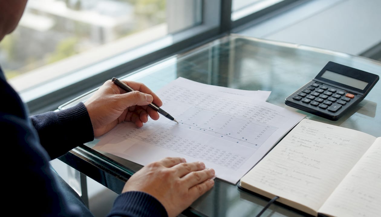 Hands calculating median absolute deviation on paper