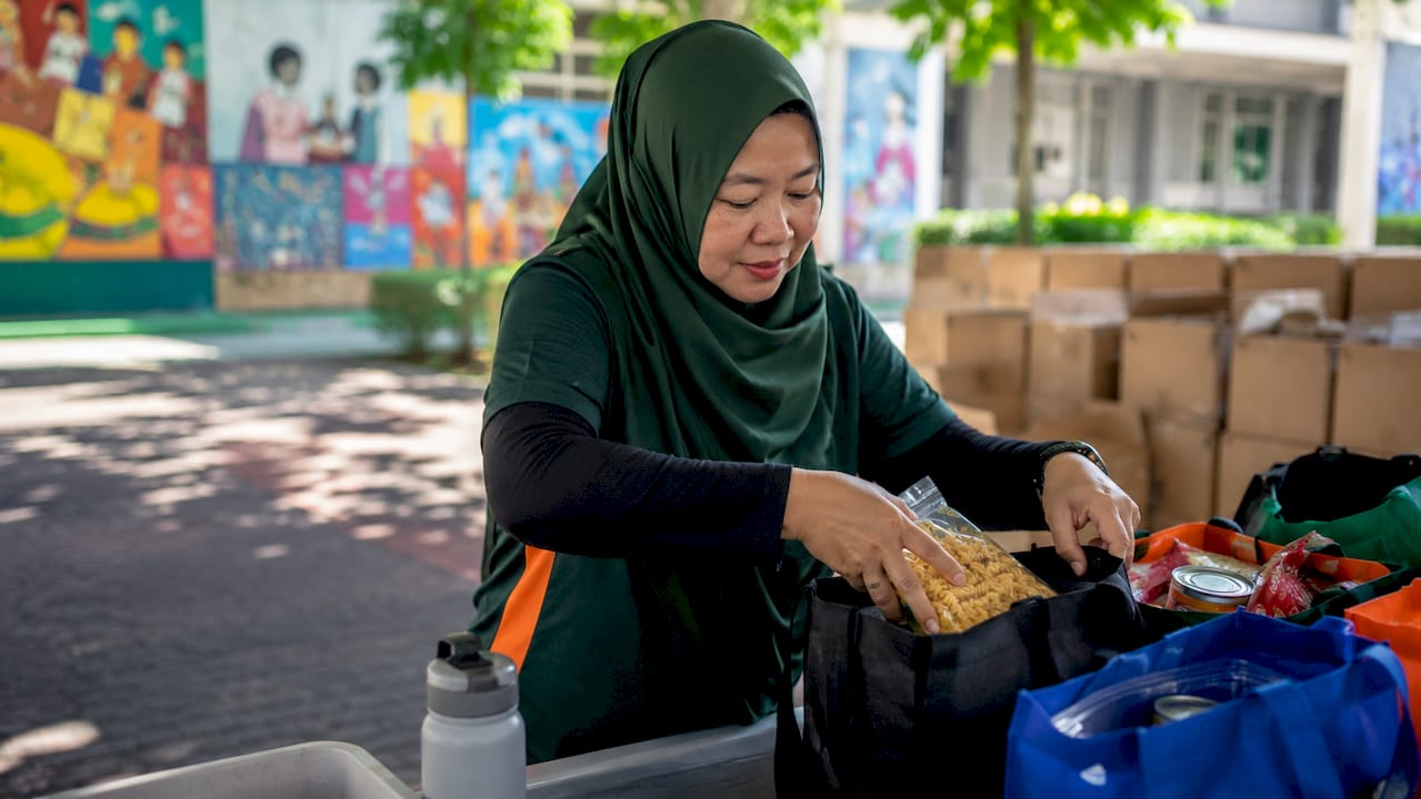 Volunteer packing food parcels for charity