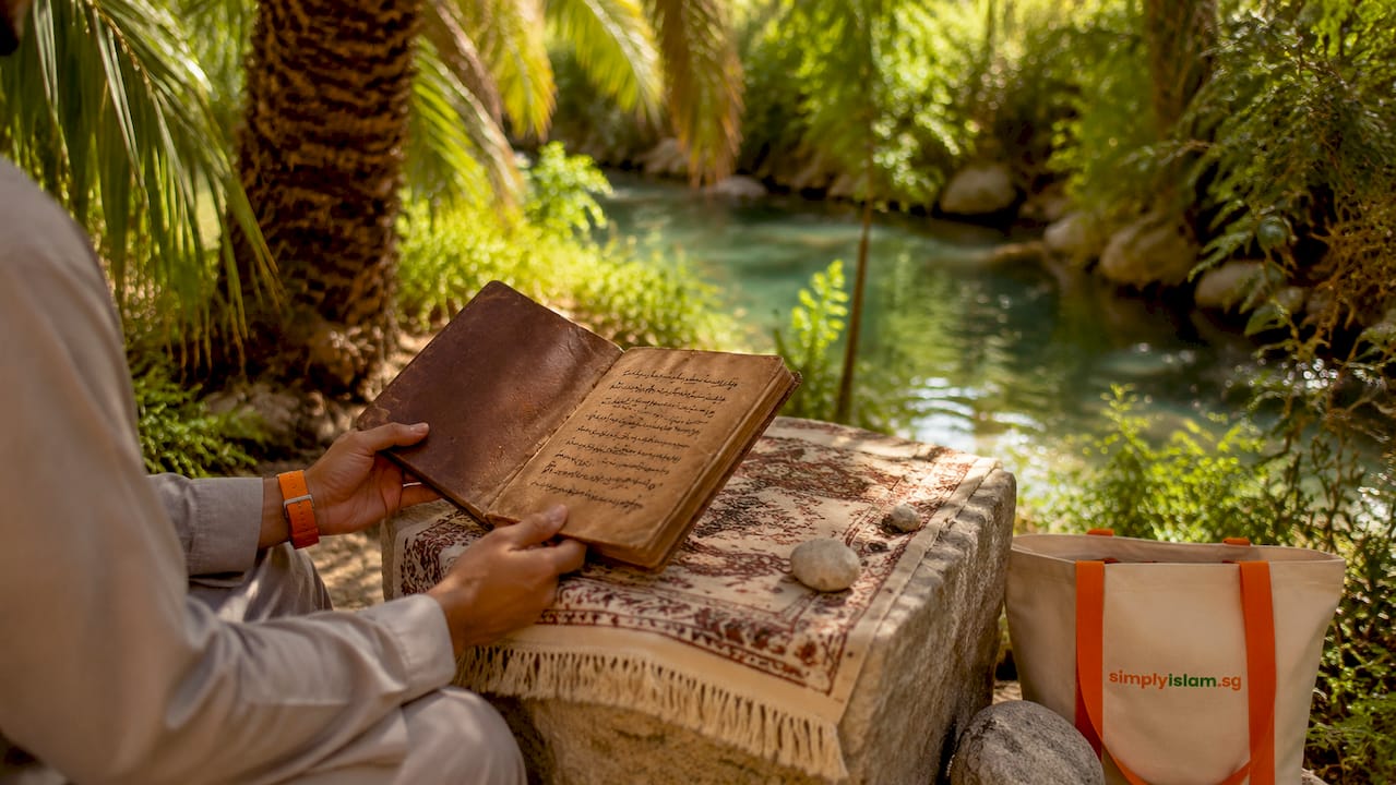 Hands holding ancient manuscript in desert tent