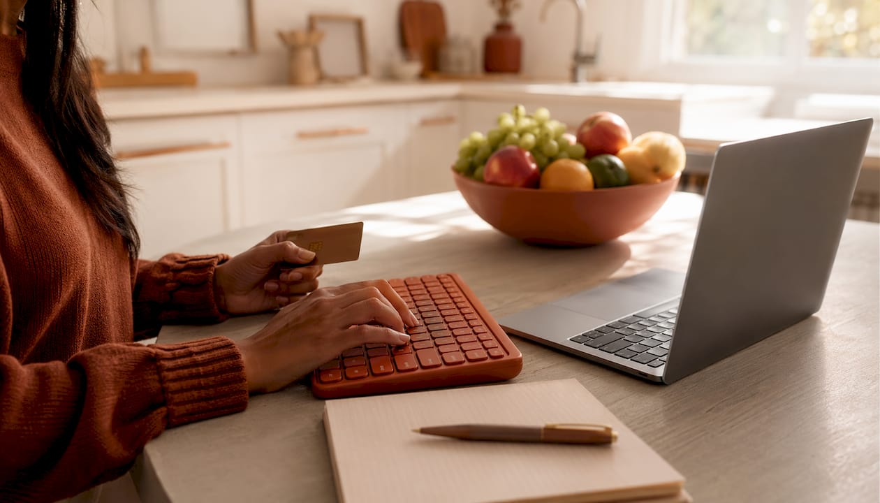 Hands typing secure payment info on laptop