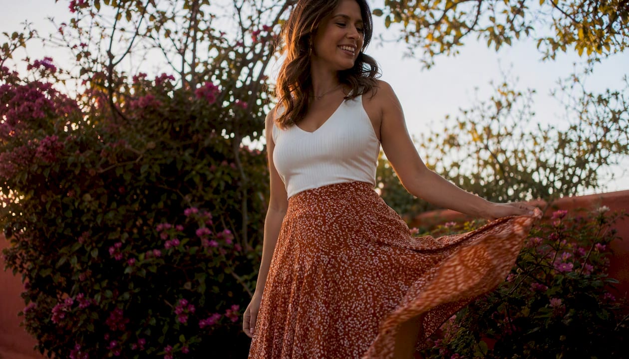 Woman showing A-line skirt with V-neck top