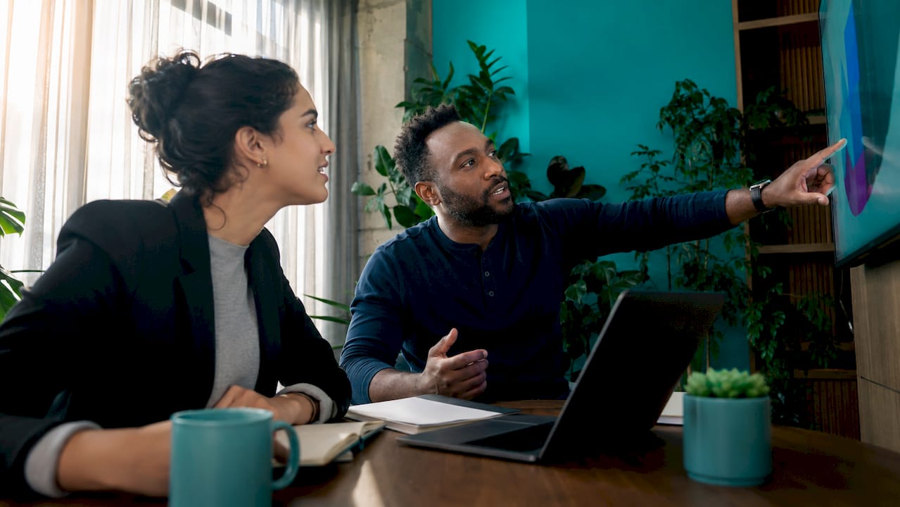 Two professionals discussing GTM strategies in office