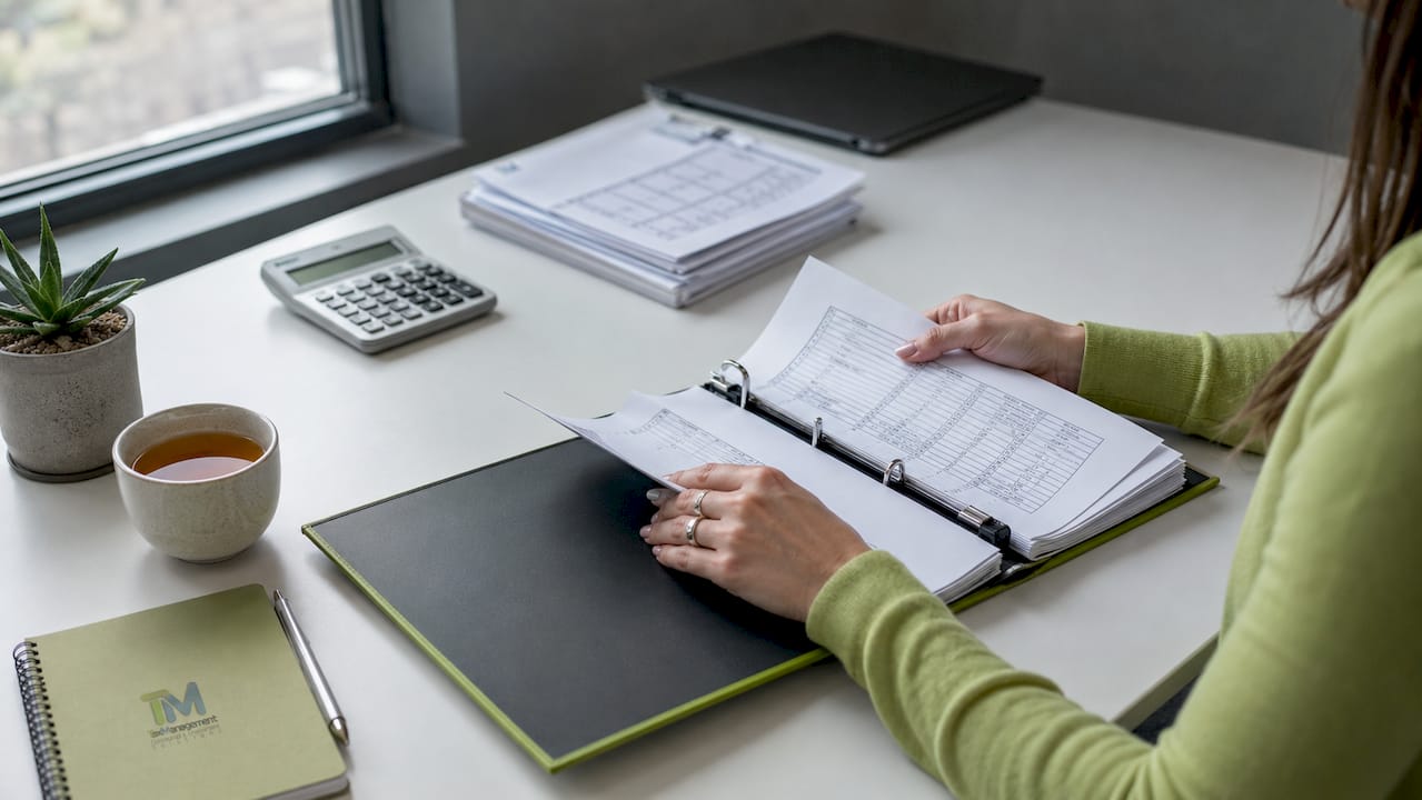 Hands filing annual financial statements paperwork