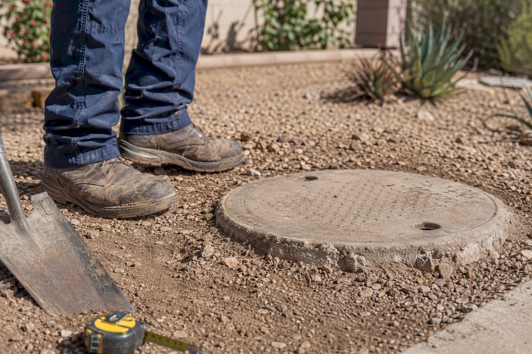 Septic tank access lid in yard during visual check