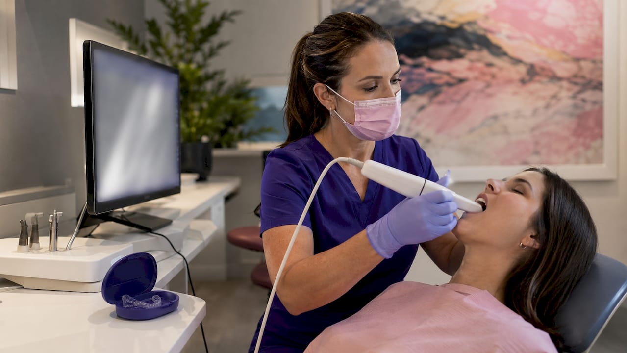 Dental professional performing digital intraoral scan