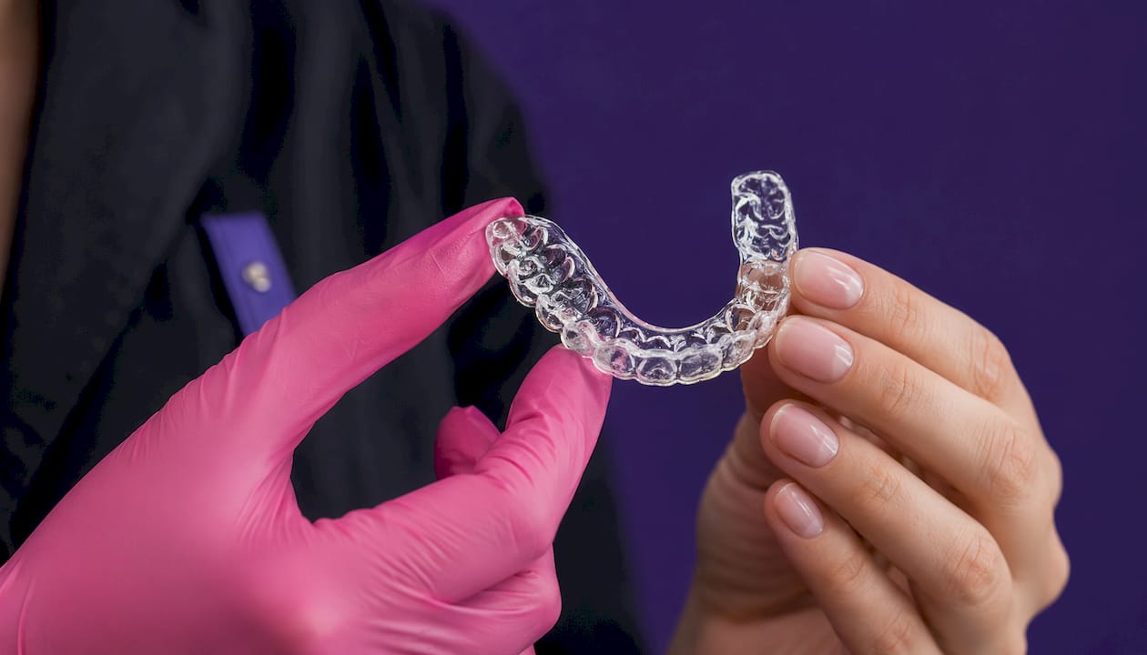 Close-up of orthodontic retainer with distal extension