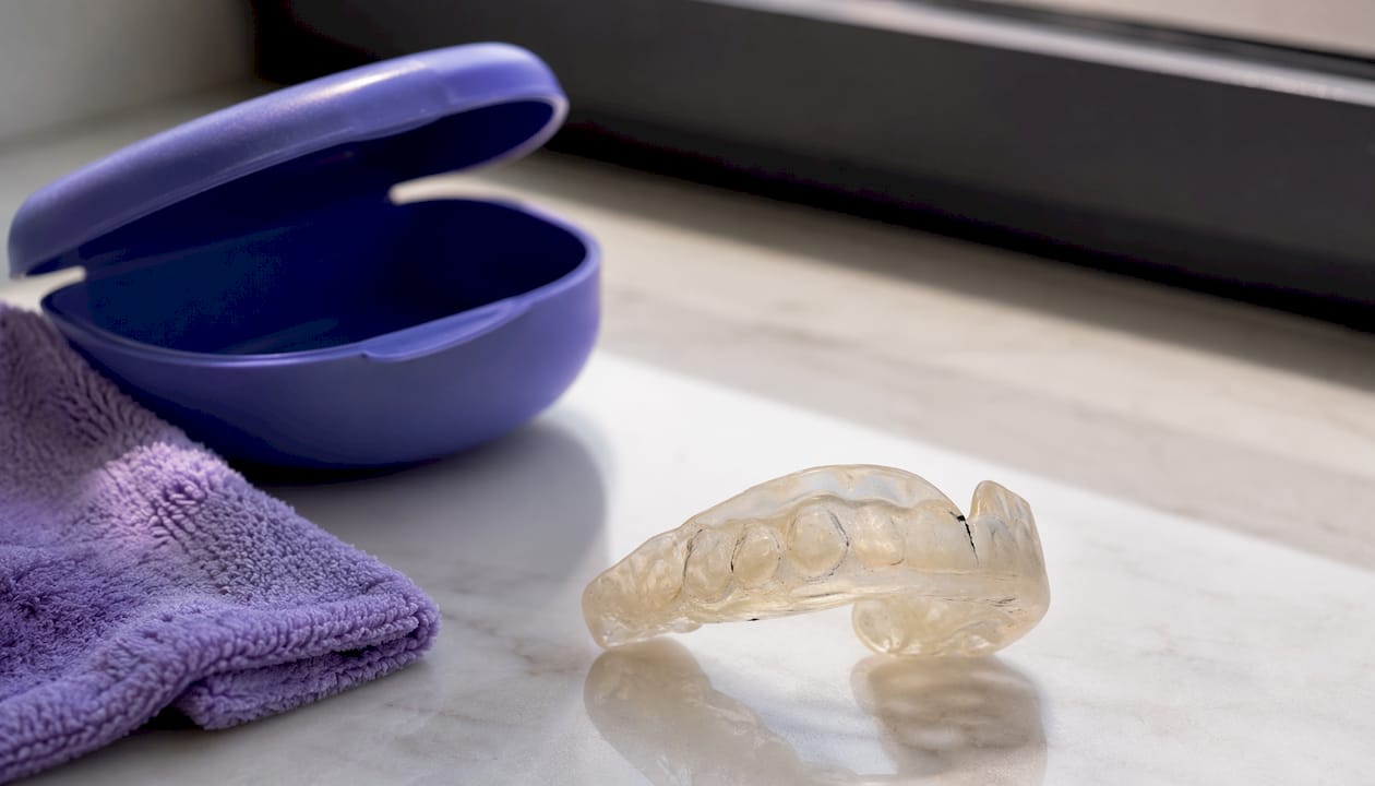 Close-up of cracked and deformed mouth guard