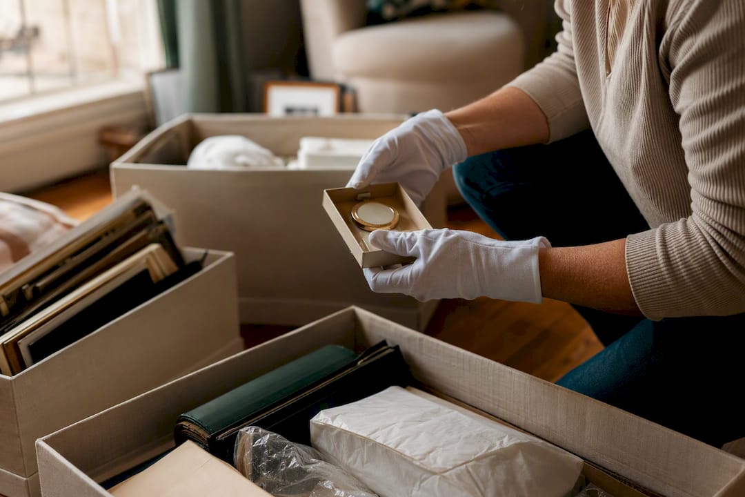 Hands sorting personal items respectfully during cleanout