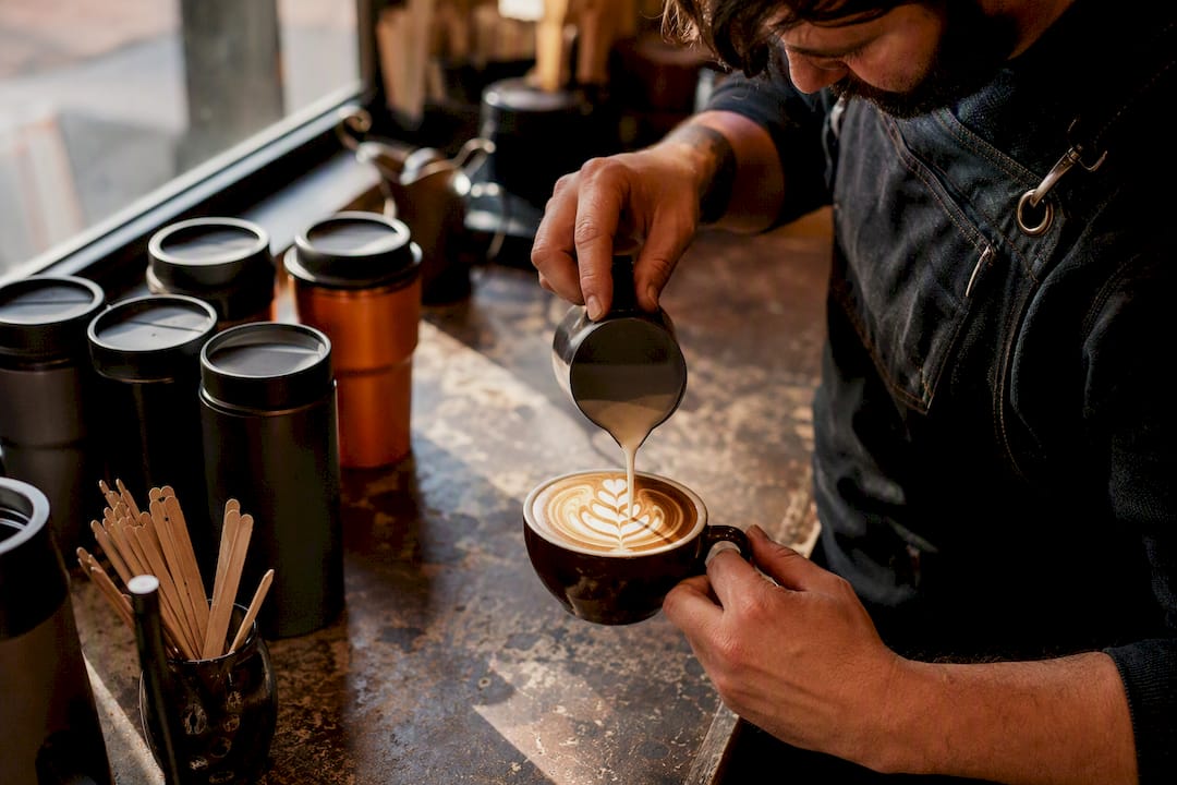 Close-up of latte art and branded cups