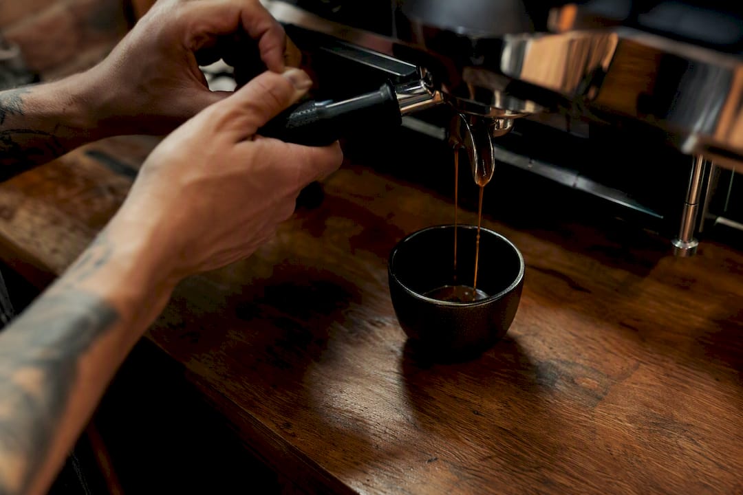 Espresso shot pouring from machine portafilter