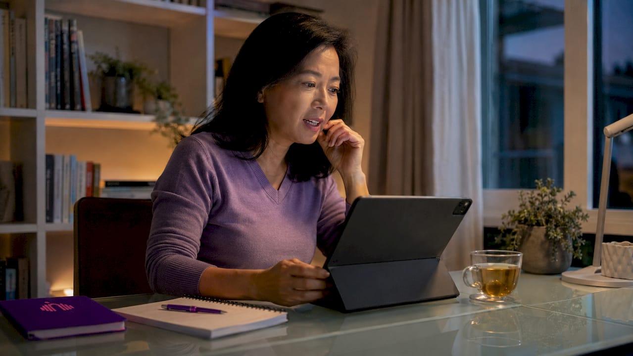 Woman practicing ESL pronunciation at home desk