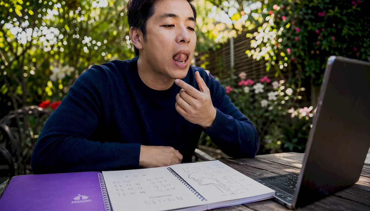 Close-up of man practicing English consonants