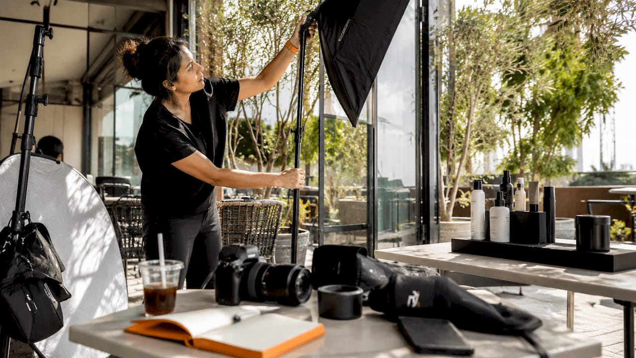 Photographer setting up a product shoot in studio