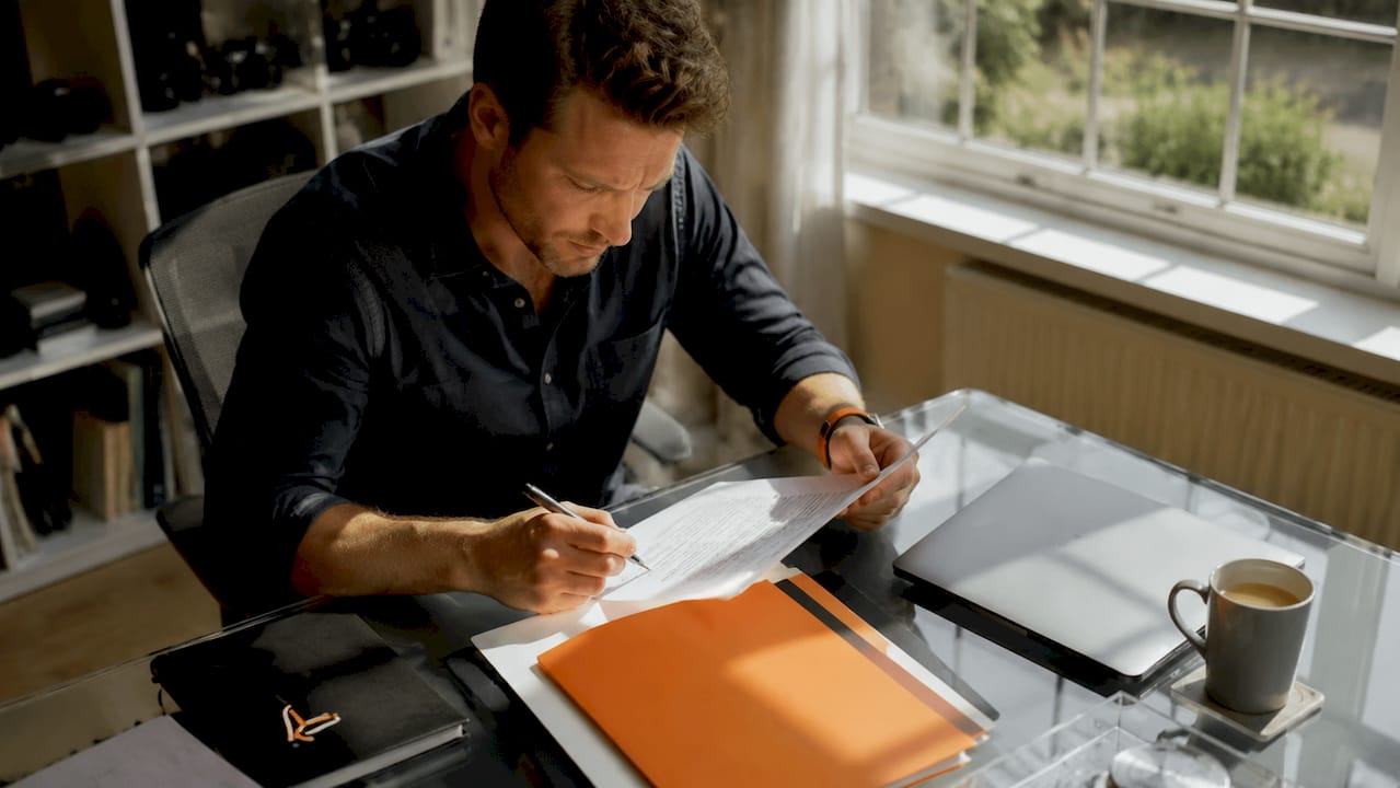 Photographer reviewing contract at desk