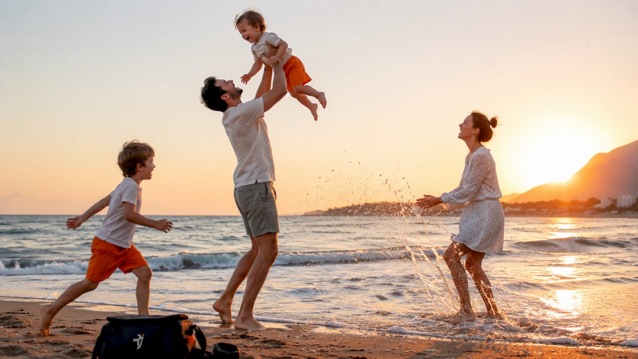 Family playing joyfully outdoors in park