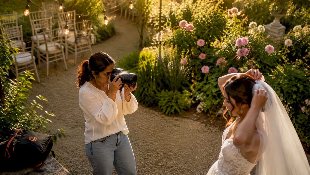 Photographer capturing bride in natural light bridal suite