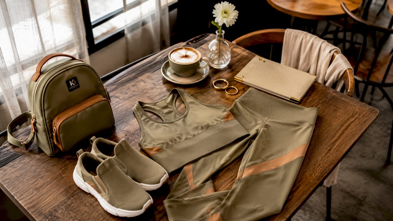 Styled activewear outfit laid out on café table