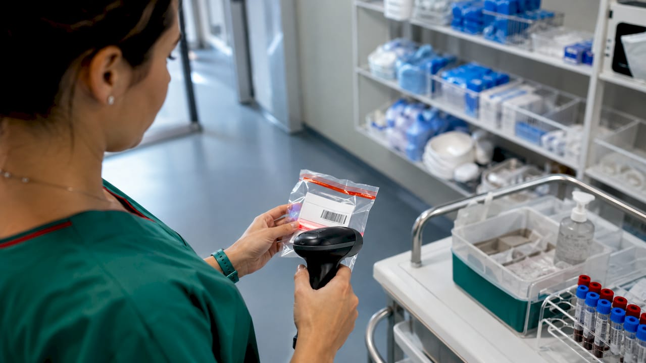 Hands scanning medical specimen package barcode