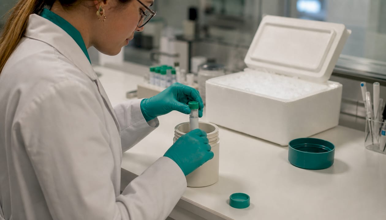 Hands assembling triple-packaging for frozen specimens