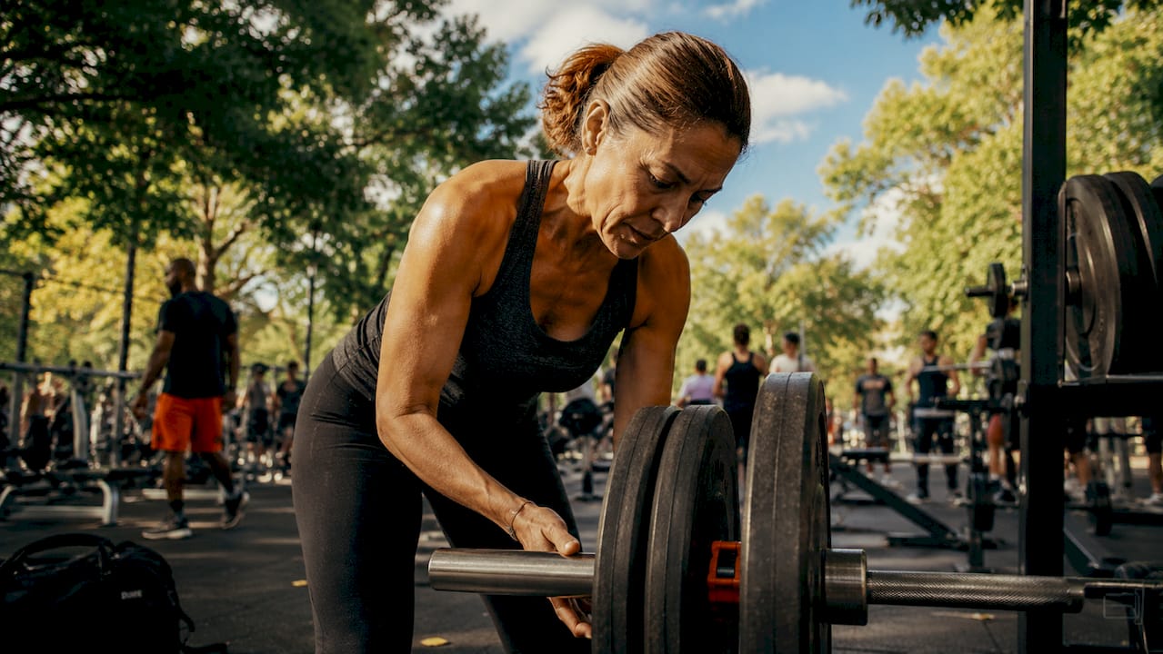 Woman adjusting gym weights at home gym