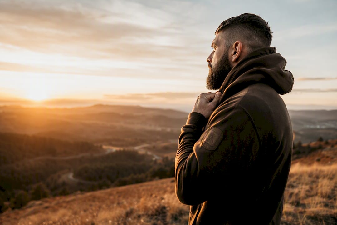 Veteran wearing hoodie outdoors at dusk