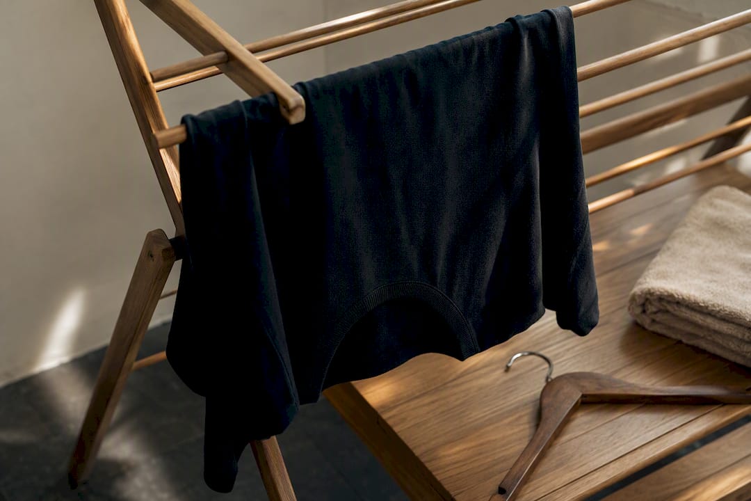 Dark garment air drying indoors away from sunlight